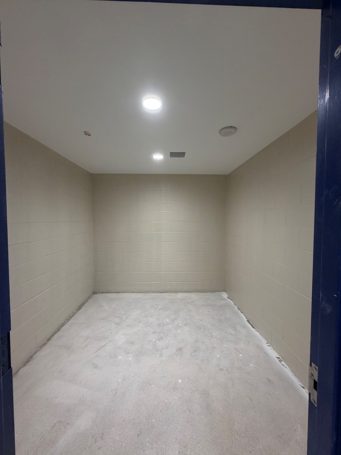 Recessed lights in a tiled interior room